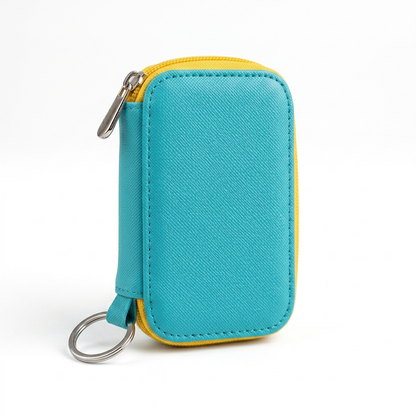 Single closed turquoise and yellow key case isolated on white background